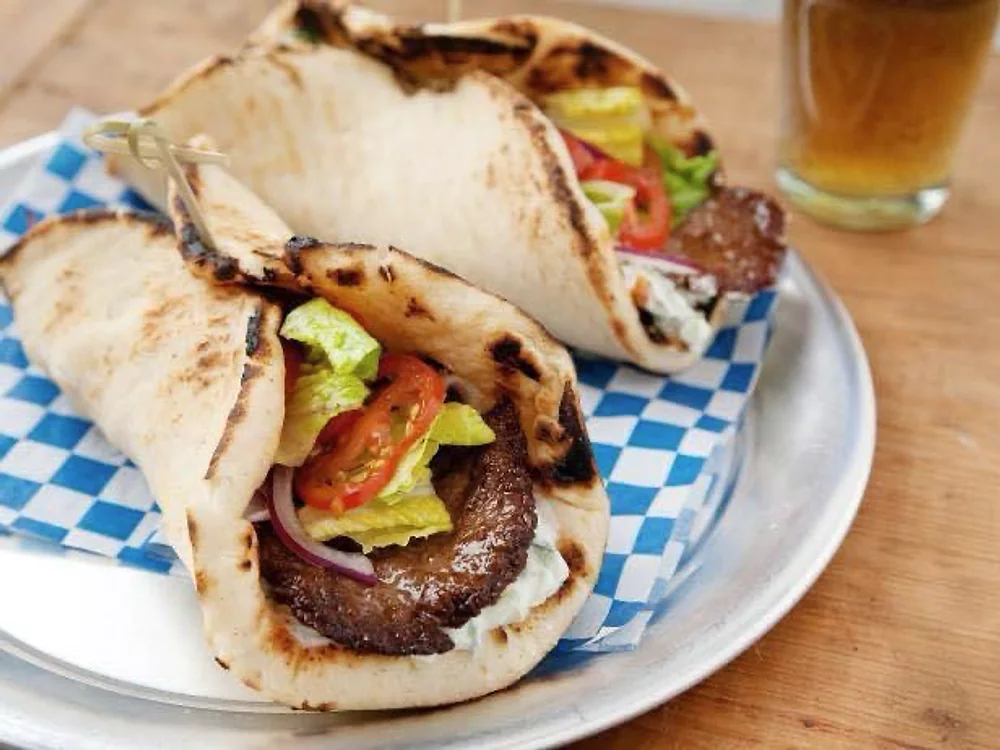 Gyro sandwiches with lettuce, tomato, onion and sauce